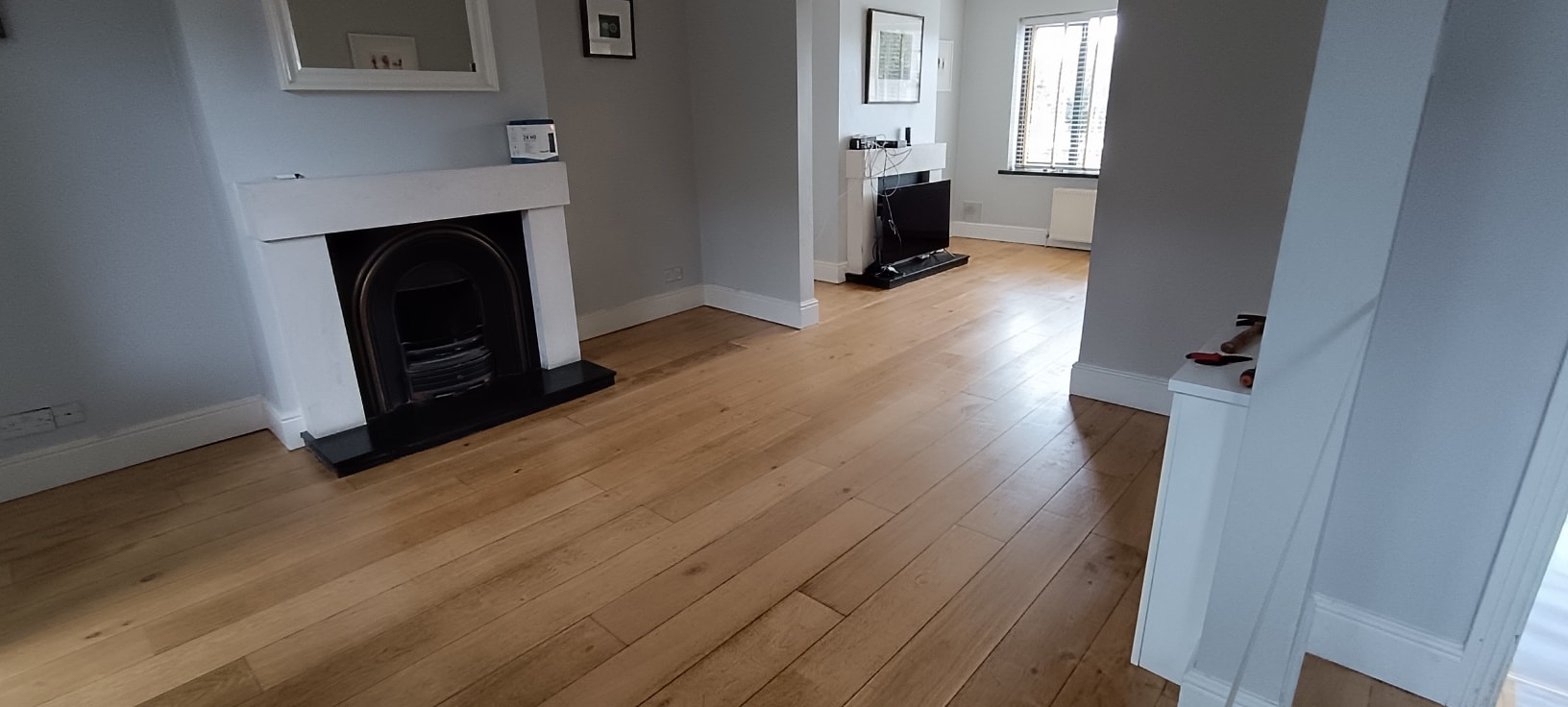 Wooden floor installation with fireplace