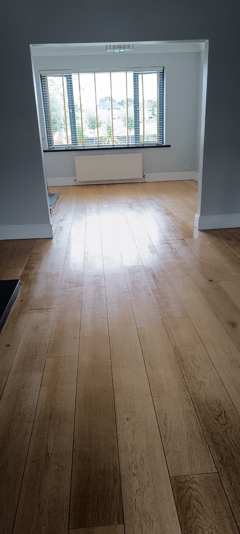 Wooden floor fitting in bay window room