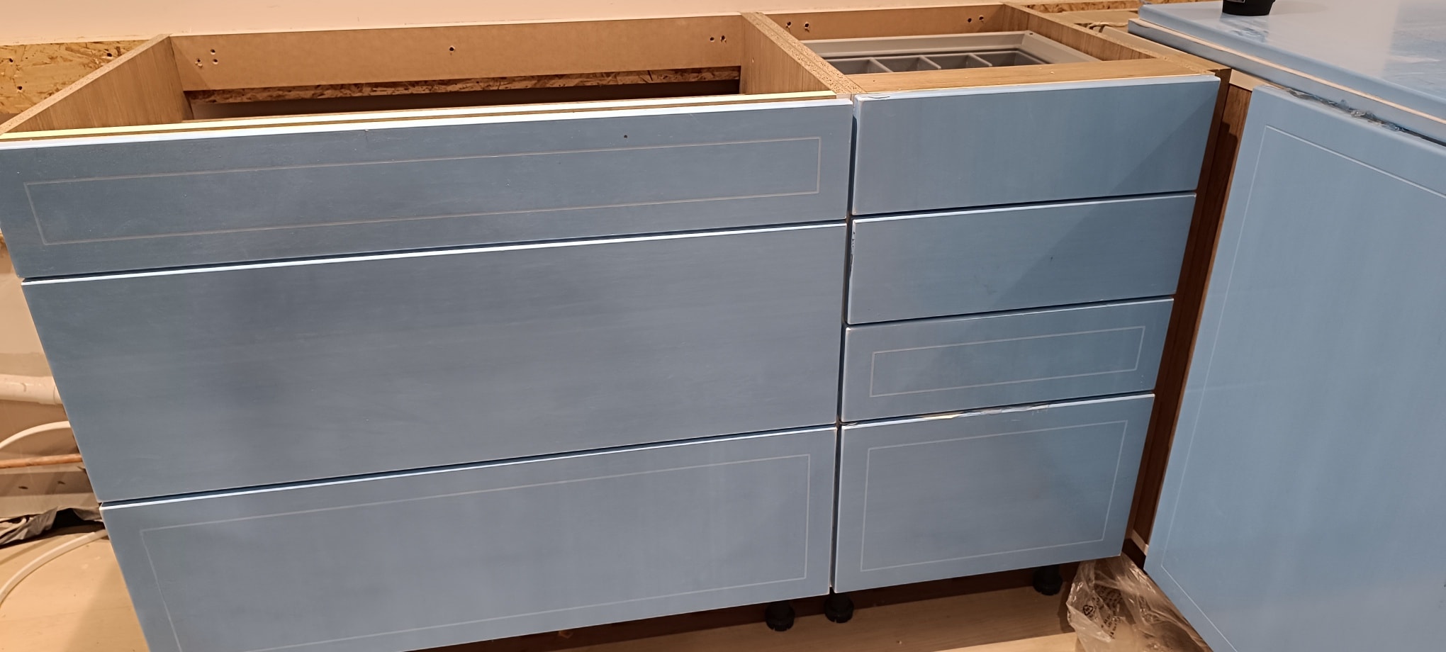 Kitchen cabinetry being fitted
